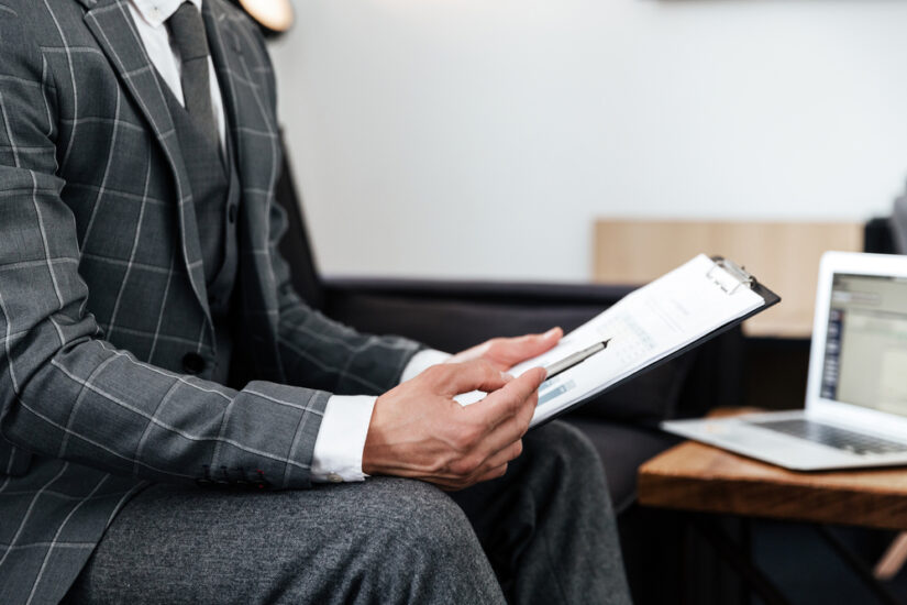 Man in Suit Analyzing Documents