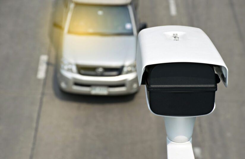 Speeding Camera Looking Down At A Driving Car