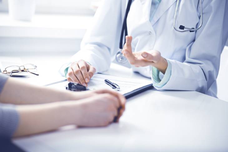 Photo of a doctor sitting at the table