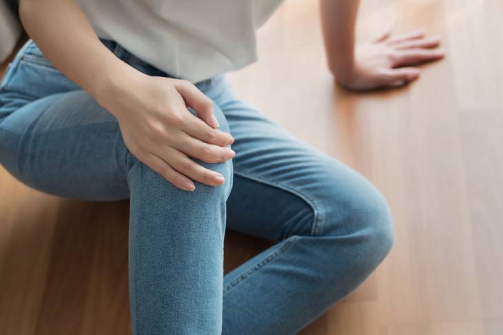 Photo of lady holding knee