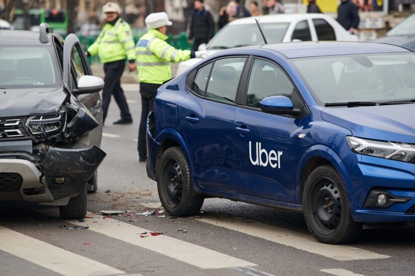 A car with Uber logo marked on the road at the place where it was involved in a car accident